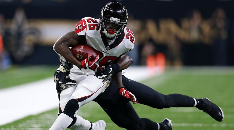 Tevin Coleman #26 of the Atlanta Falcons runs with the ball as Demario Davis #56 of the New Orleans Saints defends during the first half at the Mercedes-Benz Superdome on November 22, 2018 in New Orleans, Louisiana. (Photo by Sean Gardner/Getty Images)