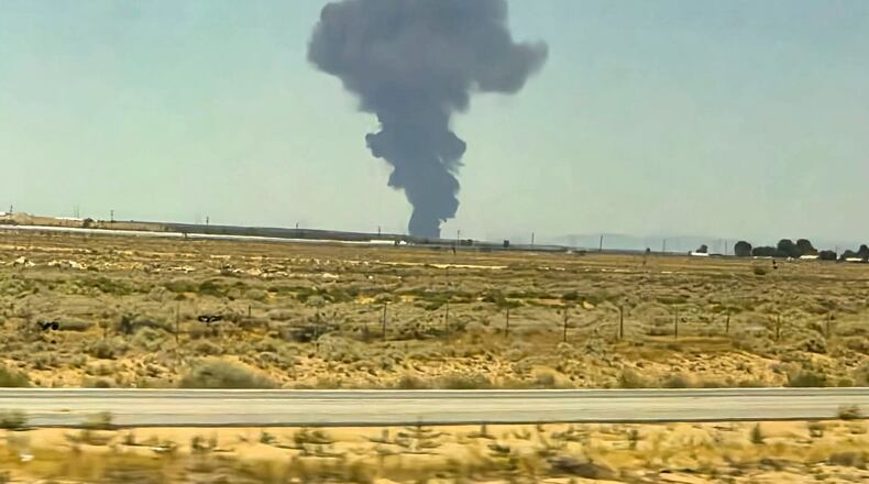 Smoke plumes rise from a B-52 bomber that crashed shortly after takeoff at a U.S. Air Force base in Southern California, Monday, June 15, 2026. (Debbie Reyes Katz via AP Photo)