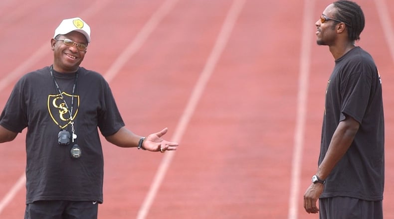 AJC file photo of legendary high school track and field coach Napoleon Cobb with star pupil Angelo Taylor at Southwest DeKalb High School.