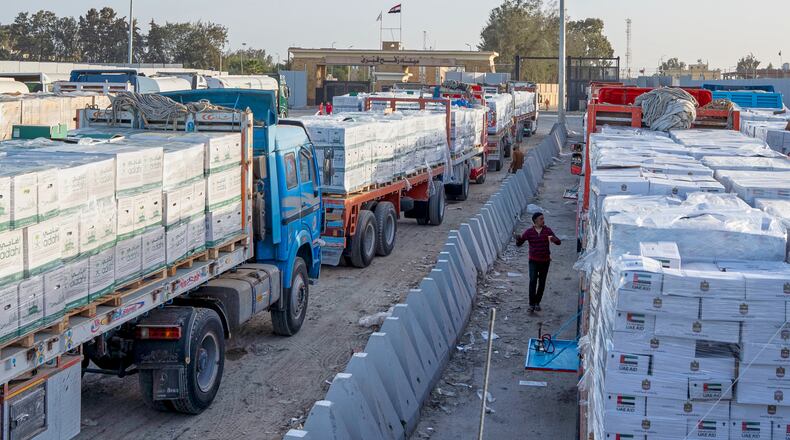 Trucks carrying humanitarian aids line up to enter the Egyptian gate of the Rafah crossing, heading for inspection by Israeli authorities before entering the Gaza Strip, in Rafah, Egypt, Sunday, Feb. 1, 2026. (AP Photo/Mohamed Arafat)