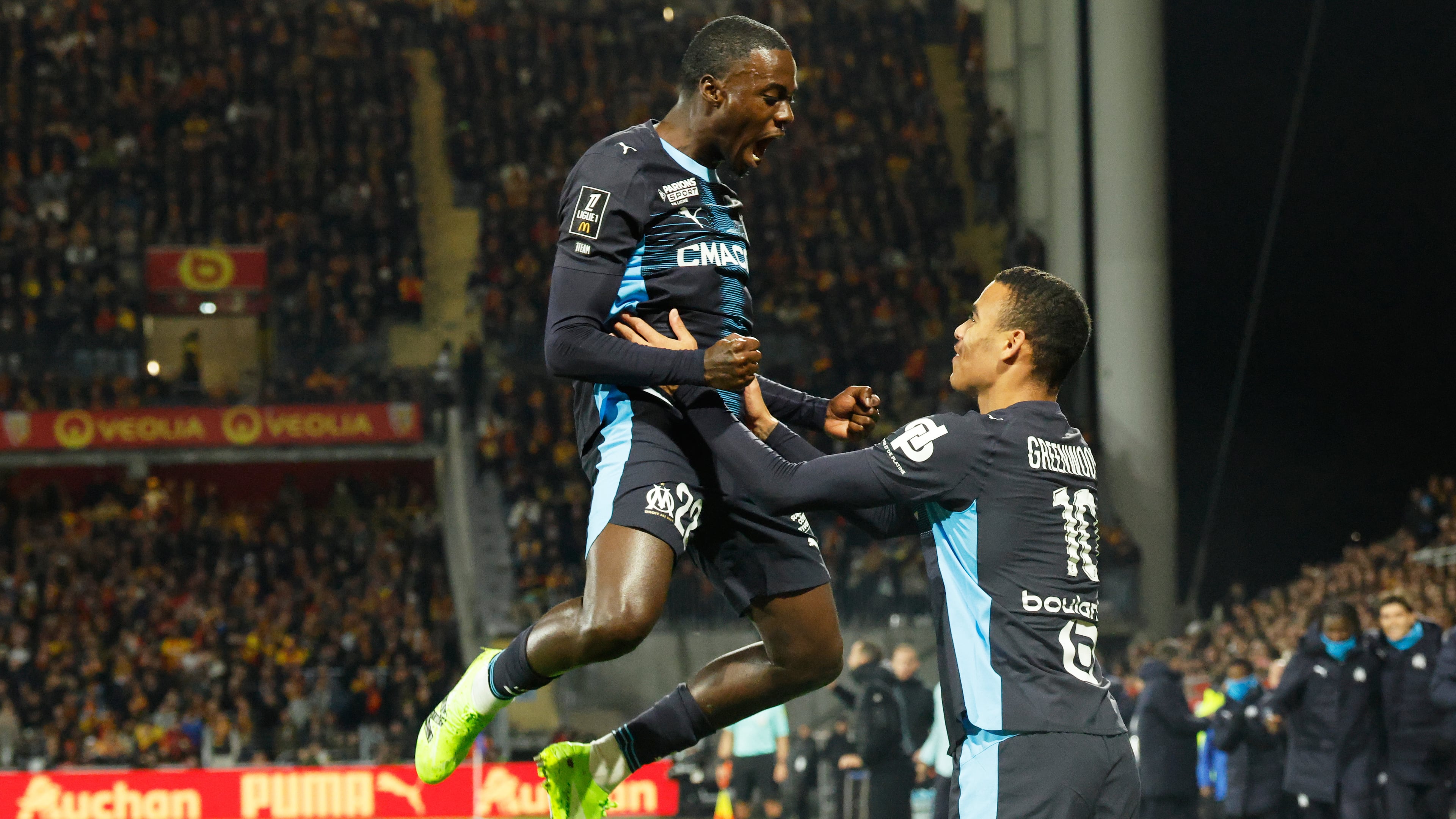 Marseille's Mason Greenwood, right, celebrates with Marseille's Timothy Weah after scoring his sides first goal during the French League One soccer match between Lens and Marseille in Lens, France, Saturday, Oct. 25, 2025. (AP Photo/Jean-Francois Badias)