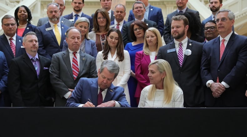 Gov. Brian Kemp signs a new package of human trafficking measures into law with his wife, Marty Kemp, at his side. The first lady made targeting human trafficking her top legislative priority after her husband was elected governor in 2018. Contributed