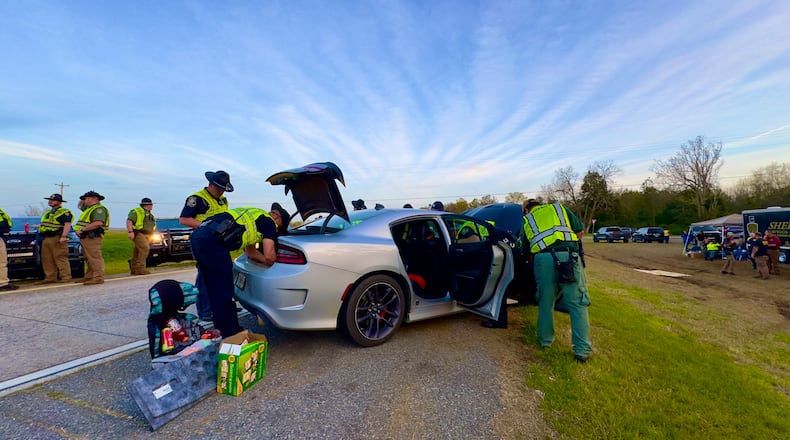 Police along I-16 in Twiggs County searching a car last weekend during the annual St. Patrick's Day license check and sobriety checkpoint they set up at an exit southeast of Macon. (Joe Kovac Jr. / joe.kovac@ajc.com)