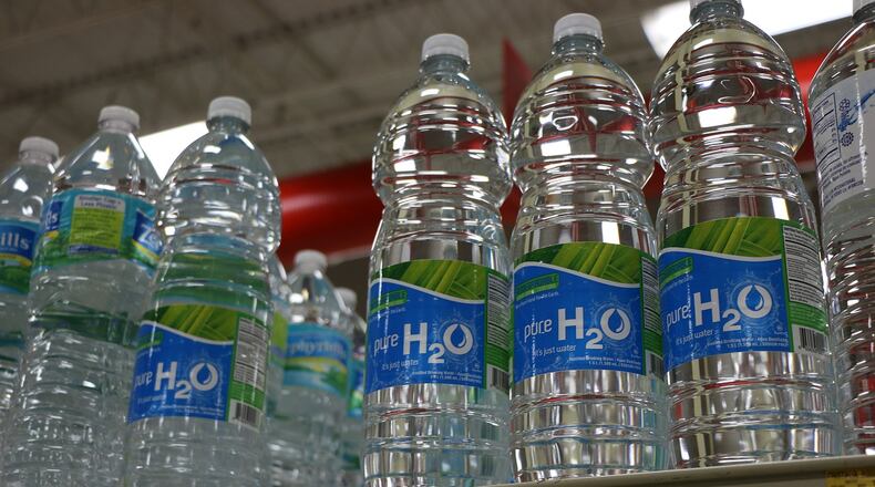 Two teenage boys selling water on an Atlanta interstate ramp were arrested after gunshots were fired when a couple refused, according to Atlanta police.