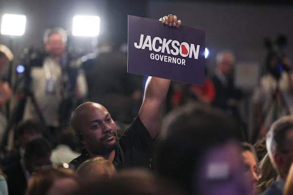 A supporter of Republican nominee for governor Rick Jackson holds a sign at Jackson’s election night party in Atlanta in May. (Jason Getz/AJC)