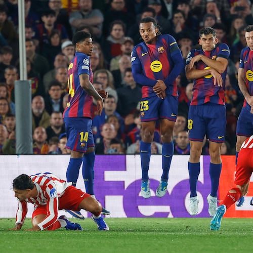 Atletico Madrid's Julian Alvarez, right, takes a free kick during the Champions League quarterfinal first leg soccer match between Barcelona and Atletico Madrid in Barcelona, Spain, Wednesday, April 8, 2026. (AP Photo/Joan Monfort)