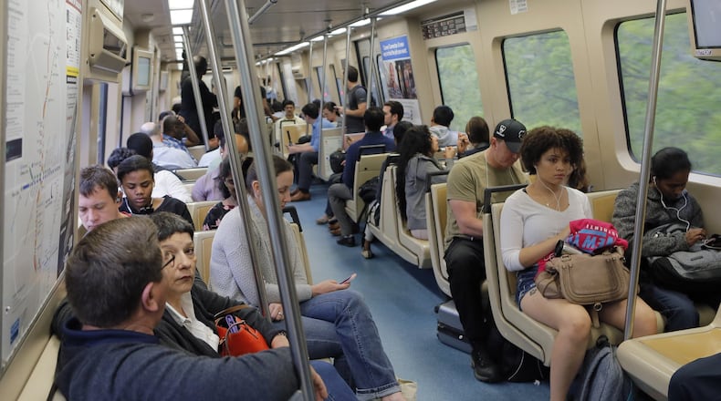 This southbound MARTA train was full but not over crowded as it headed south from North Springs station. Passengers on both the Red and Blues lines were saying parking lots were full. A portion of I-85 remains closed because of Thursday’s fire and bridge collapse. Fulton County plans to provide free rides for employees and jurors. BOB ANDRES /BANDRES@AJC.COM AJC File Photo