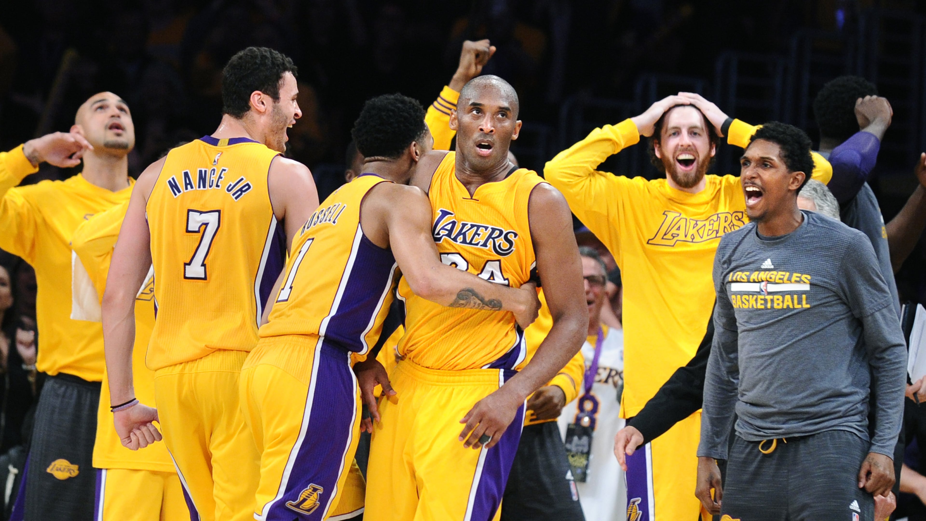 Los Angeles Lakers star Kobe Bryant is mobbed by teammates after scoring 60 points in his final NBA game in 2016. Bryant was a No. 13 draft pick. (Wally Skalij/Los Angeles Times)
