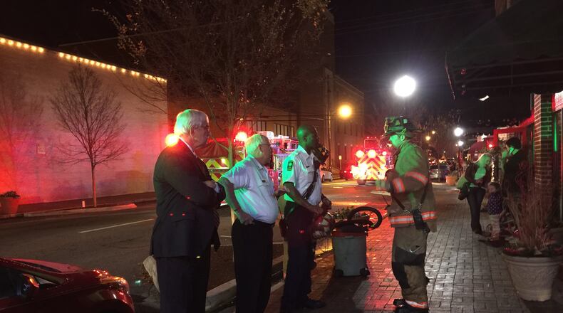 Marietta Mayor Steve Tumlin and other officials survey damage at Planet Ink Tattoos.
