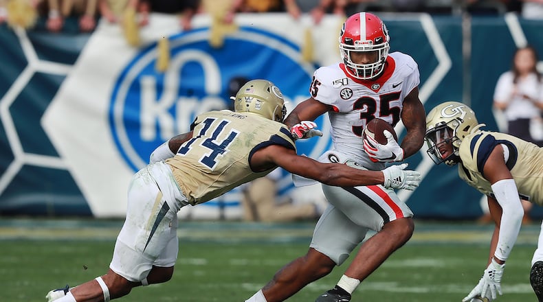 November 30, 2019 Atlanta: Georgia tailback Brian Herrien picks up yardage past Georgia Tech defensive back Jaylon King during the second half in a NCAA college football game on Saturday, November 30, 2019, in Atlanta. Curtis Compton/ccompton@ajc.com