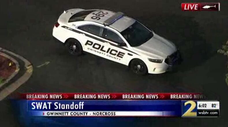 Police said a potentially armed man locked himself in a Norcross hotel room.