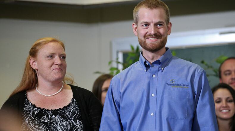 EBOLA VICTIM GOES HOME--August 21, 2014 Dekalb County: Dr. Kent Brantly stood with his wife Amber and made a statement at Emory University Hospital annex following his discharge from the facility after being successfully treated for Ebola Thursday, Aug. 21, 2014. Bruce Ribner, MD, medical director of Emory's Infectious Disease Unit, discussed the discharge of Brantly and the discharge of patient, missionary Nancy Writebol, who also had contracted the Ebola virus. JOHN SPINK/JSPINK@AJC.COM
