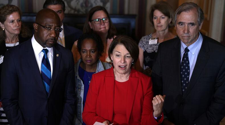In this photo from July 14, 2021, U.S. Sen. Amy Klobuchar (D-MN) (C), Sen. Raphael Warnock (D-GA) (L) and Sen. Jeff Merkley (D-OR) (R) speak to reporters after a meeting with members of Texas House Democratic Caucus at the U.S. Capitol in Washington, DC. (Alex Wong/Getty Images/TNS)