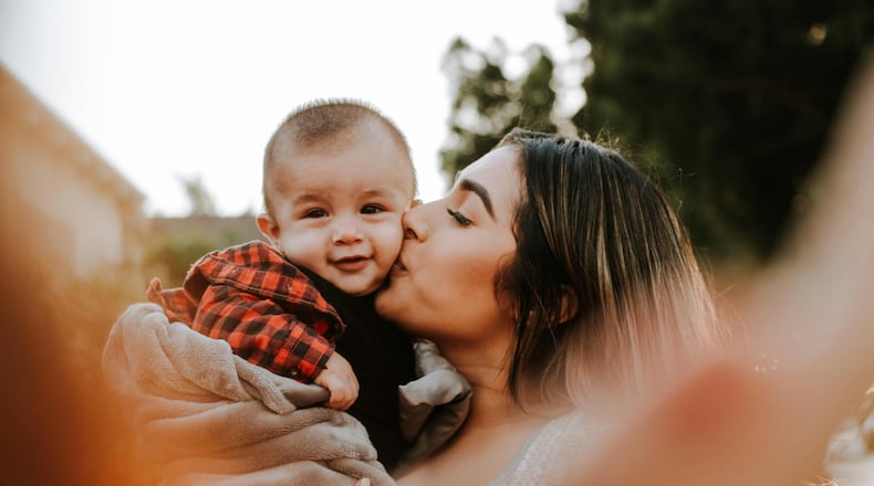 Mother holding her baby. (Omar Lopez/Unsplash)
