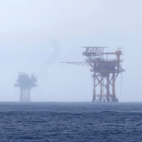 FILE - Oil platforms are visible through the haze near the Flower Garden Banks National Marine Sanctuary in the Gulf of Mexico, off the coast of Galveston, Texas, Saturday, Sept. 16, 2023. (AP Photo/LM Otero, File)