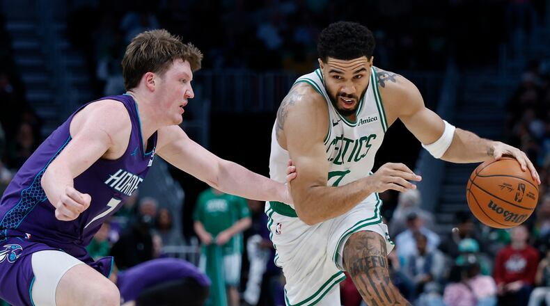 Boston Celtics forward Jayson Tatum, right, drives against Charlotte Hornets guard Kon Knueppel during the second half of an NBA basketball game in Charlotte, N.C., Sunday, March 29, 2026. (AP Photo/Nell Redmond)
