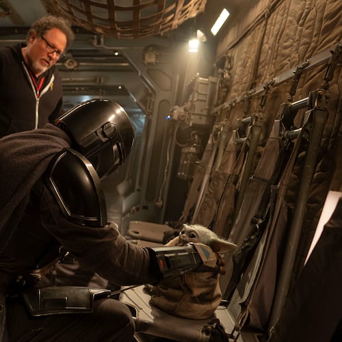 This image released by Disney shows director Jon Favreau, left, and Pedro Pascal on the set of Lucasfilm's "Star Wars: The Mandalorian and Grogu." (Francois Duhamel/Lucasfilm Ltd./Disney via AP)