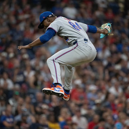 After striking out Cleveland Guardians' Angel Martinez during his Major League debut, New York Mets relief pitcher Jefry Yan reacts during the sixth inning of a baseball game, Wednesday, Aug. 5, 2026, in Cleveland. (AP Photo/Phil Long)