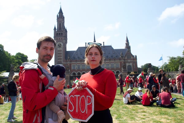 Roos Lingbeek, right, husband Stijn Joosten and daughter Dido stand in front of the Peace Palace during the Red Line protest in The Hague, Netherlands on Sunday, May 18, 2025. (Niels van der Pas via AP)