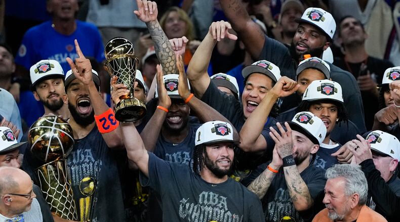New York Knicks guard Jalen Brunson holds the MVP trophy after the Knicks defeated the San Antonio Spurs in Game 5 of the NBA Finals basketball series, Saturday, June 13, 2026, in San Antonio. (AP Photo/Ross D. Franklin)