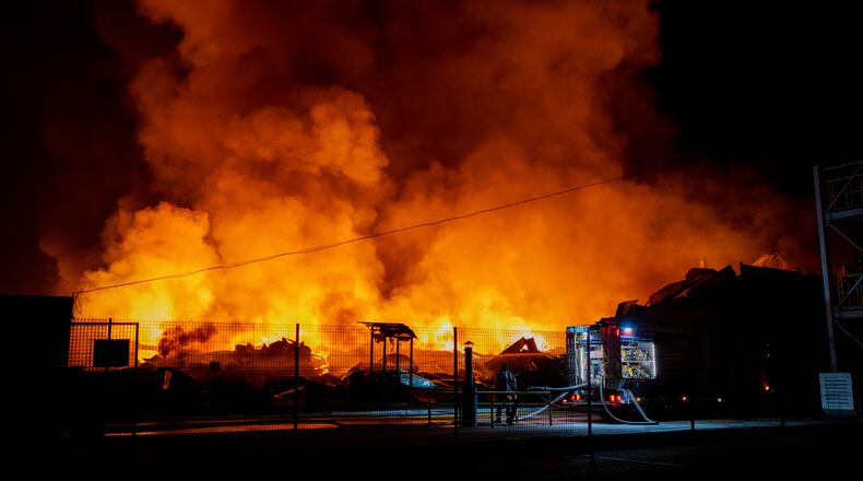 Firefighters put out a fire after Russian missiles hit a warehouse in Kyiv, Ukraine, Wednesday, Aug. 5, 2026. (AP Photo/Dan Bashakov)