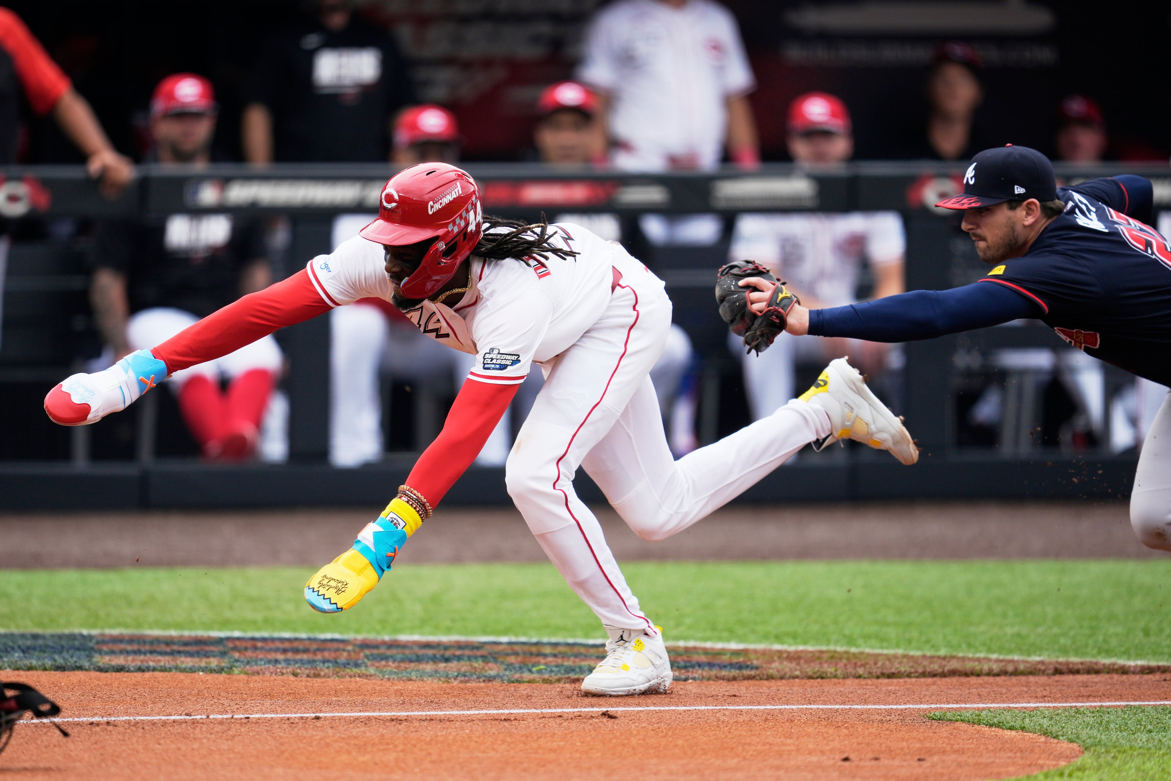 The Reds' Elly De La Cruz is out near home during the (continued) first inning of the Speedway Classic.
