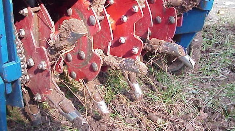 Homeowners can successfully aerate a lawn if they can handle a heavy machine. CONTRIBUTED BY WALTER REEVES
