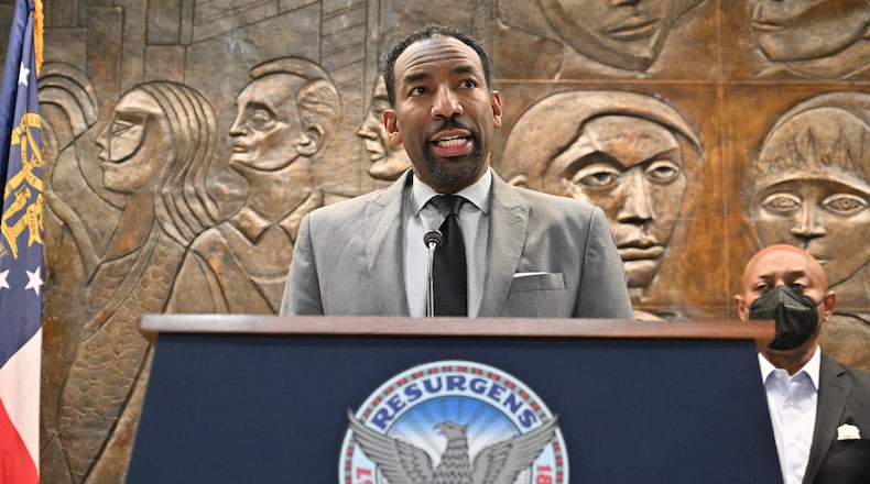 February 3, 2022 Atlanta - Mayor Andre Dickens announces the settlement with Integral Group CEO Egbert Perry (not pictured) and the Atlanta Housing Authority President Eugene Jones (right) during a press conference at Atlanta City Hall on Thursday, February 3, 2022. (Hyosub Shin / Hyosub.Shin@ajc.com)