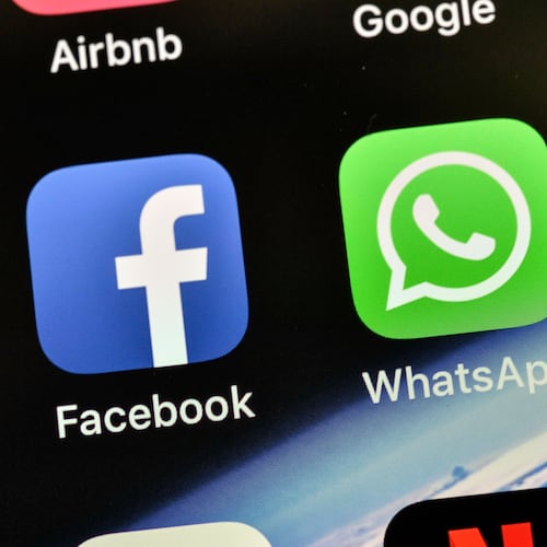 FILE - In this Thursday, Nov. 15, 2018 file photo the icons of Facebook and WhatsApp are pictured on an iPhone in Gelsenkirchen, Germany. (AP Photo/Martin Meissner,File)