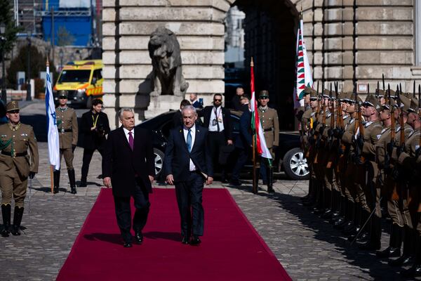 Israeli Prime Minister Benjamin Netanyahu, right, and Hungarian Prime Minister Viktor Orban, left, participate in a welcoming ceremony with a guard of honor at Buda Castle in Budapest, Hungary, April 3, 2025. (AP Photo/Denes Erdos)