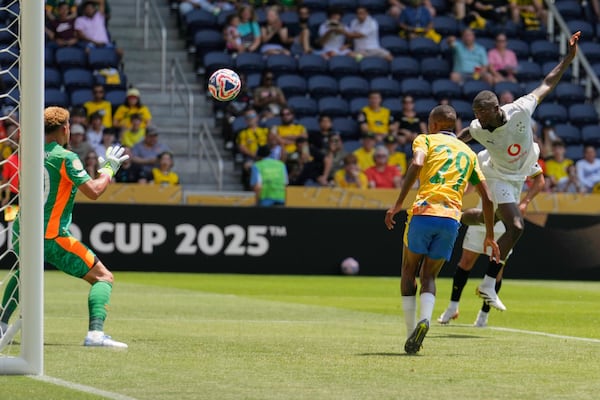 Borussia Dortmund's Serhou Guirassy, right, heads at goal during the Club World Cup Group F soccer match between Mamelodi Sundowns and Borussia Dortmund in Cincinnati, Saturday, June 21, 2025. (AP Photo/Carolyn Kaster)