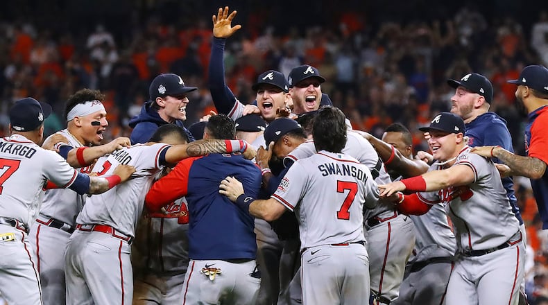 The Braves charge the mound to celebrate beating the Astros in game 6 to win the World Series on Tuesday, Nov. 2, 2021, in Houston. Curtis Compton / Curtis.Compton@ajc.com