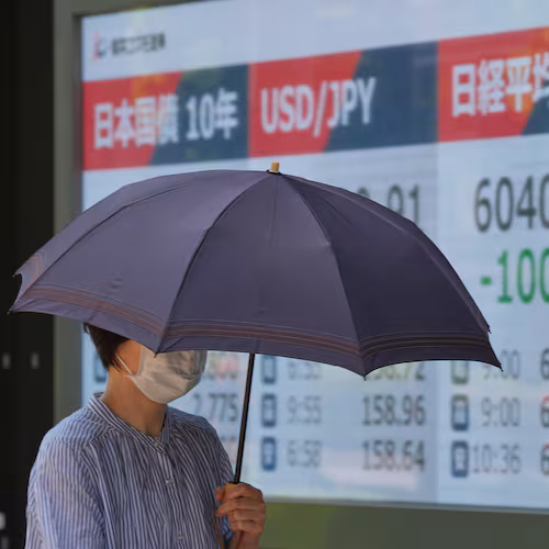 A person walks in front of an electronic stock board showing Japan's Nikkei index at a securities firm Monday, May 18, 2026, in Tokyo. (AP Photo/Eugene Hoshiko)