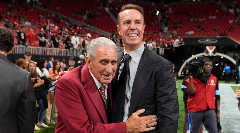 FILE - Atlanta Falcons owner Arthur Blank, left, talks to former quarterback Matt Ryan before an NFL football game against the Tampa Bay Buccaneers Oct. 3, 2024, in Atlanta. (AP Photo/John Bazemore, File)
