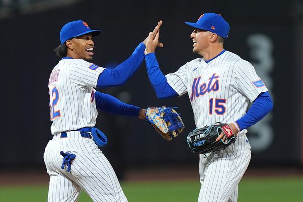 New York Mets' Francisco Lindor (12) celebrates with Tyrone Taylor (15) after a baseball game against the Philadelphia Phillies Monday, April 21, 2025, in New York. (AP Photo/Frank Franklin II)