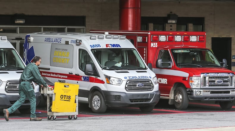 Ambulances from various services are lined up at Grady Hospital in May. Critics say Georgia’s system of selecting ambulance providers needs a major overhaul.