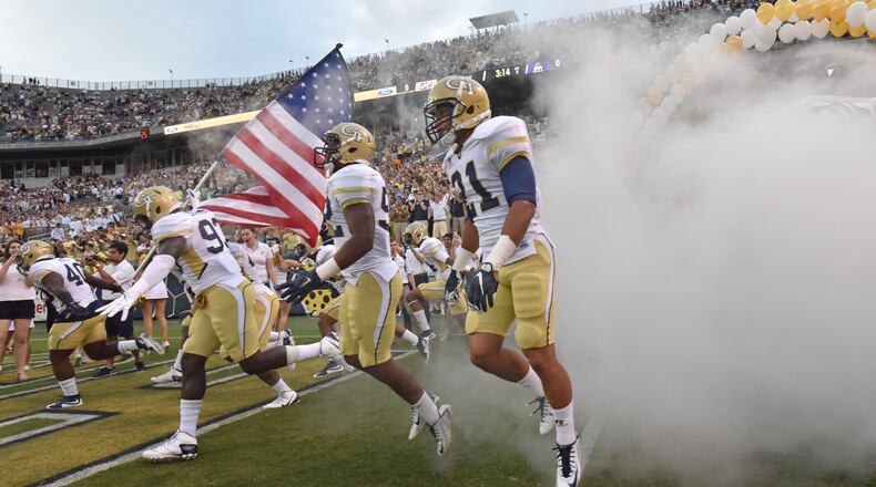 Georgia Tech players run on to the field before the start of the Tech season opener against the Alcorn State Braves in Bobby Dodd Stadium on Thursday, September 3, 2015. HYOSUB SHIN / HSHIN@AJC.COM
