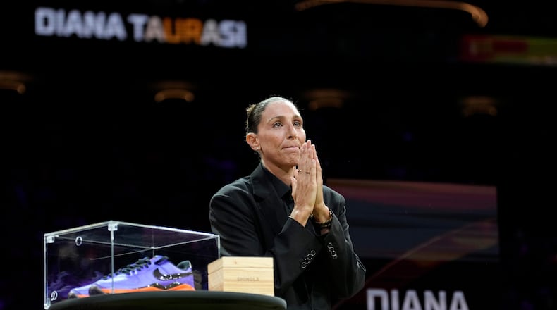 Retired WNBA Phoenix Mercury basketball player Diana Taurasi acknowledges the cheering crowd as she is honored during a halftime Ring of Honor ceremony Sunday, Aug. 16, 2026, in Phoenix. (AP Photo/Ross D. Franklin)