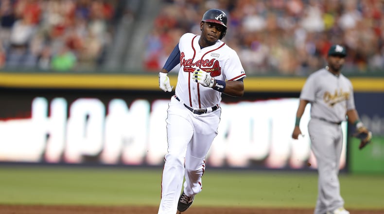 ATLANTA, GA - AUGUST 15: Left fielder Justin Upton #8 of the Atlanta Braves runs past second base after hitting a solo home run in the second inning of the game against the Oakland Athletics at Turner Field on August 15, 2014 in Atlanta, Georgia. (Photo by Mike Zarrilli/Getty Images)