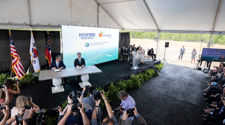 ELLABELL, GEORGIA - MAY 20, 2022: Governor Brian P. Kemp, center left, and
Hyundai Motor Group President and CEO Jae Hoon Chang, center right, sign a ceremonial document at the announcement that the South Korean automotive giant is building an electric vehicle plant in Ellabell, Ga. Hyundai plans to build a multi-billion-dollar electric vehicle assembly and battery plant outside of Savannah that eventually could employ about 8,100 workers. (AJC Photo/Stephen B. Morton)