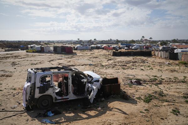 The wreckage of a car struck earlier by an Israeli army attack that killed at least seven people, six of them the Abu Mahadi brothers, sits on the outskirts of Deir al-Balah, in the central Gaza Strip, Sunday, April 13, 2025. (AP Photo/Abdel Kareem Hana)