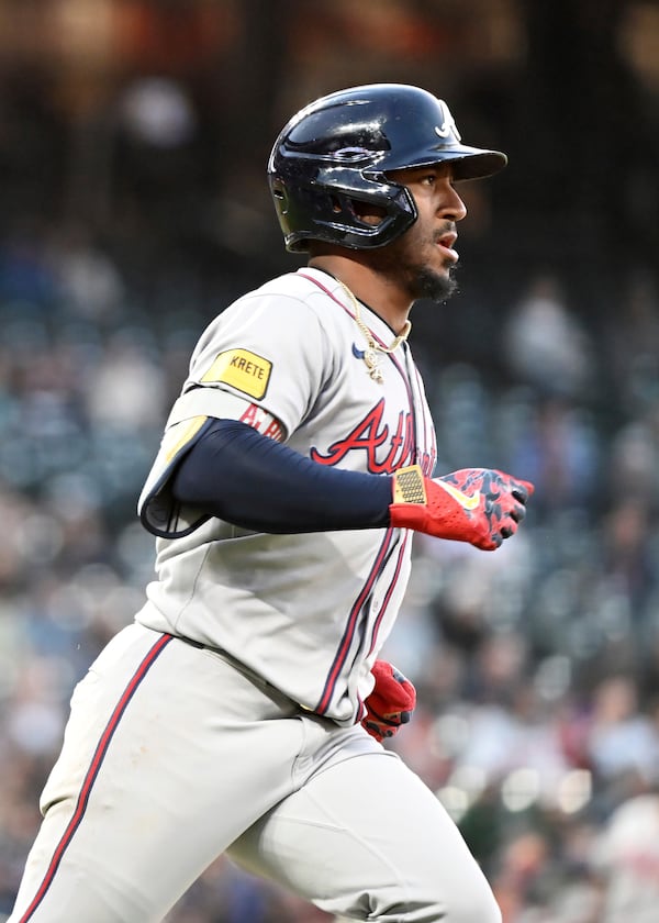 Atlanta Braves' Ozzie Albies (1) runs to second base after a fielding error by Colorado Rockies right fielder Mickey Moniak (22) in the fifth inning of a baseball game Tuesday, April 29, 2025, in Denver. (AP Photo/Geneva Heffernan)