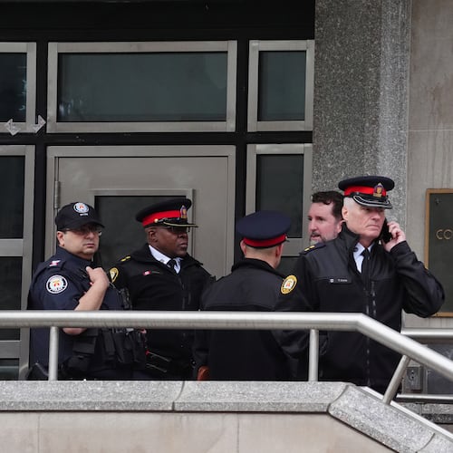 FILE - Toronto police officers investigate outside the U.S. consulate in Toronto on March 10, 2026. (Frank Gunn/The Canadian Press via AP, File)