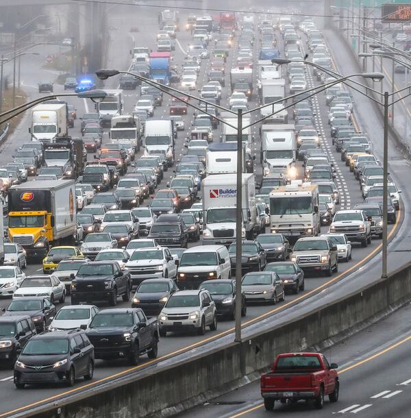 Atlanta Downtown Connector on February 15, 2021, when all southbound lanes were shut down for most of the afternoon after a tractor-trailer wrecked on a bridge and dislodged several yards of chain-link fencing. (John Spink / John.Spink@ajc.com)


