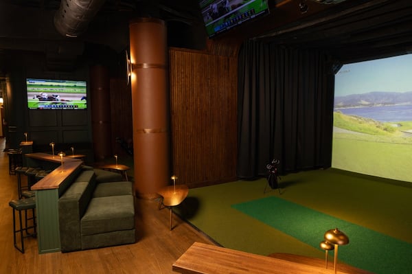 An upscale sports bar with a golf simulator