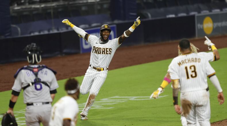 San Diego Padres' Jurickson Profar celebrates a game-winning hit in the bottom of the 9th inning.