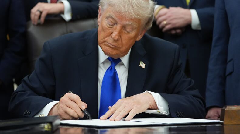 President Donald Trump signs a presidential permit regarding pipeline construction in the Oval Office of the White House, Thursday, April 30, 2026, in Washington. (AP Photo/Alex Brandon)