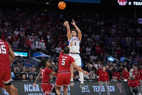 Florida guard Walter Clayton Jr. (1) shoots a three pointer over Texas Tech forward Darrion Williams (5) during the second half in the Elite Eight of the NCAA college basketball tournament, Saturday, March 29, 2025, in San Francisco. (AP Photo/Marcio Jose Sanchez)