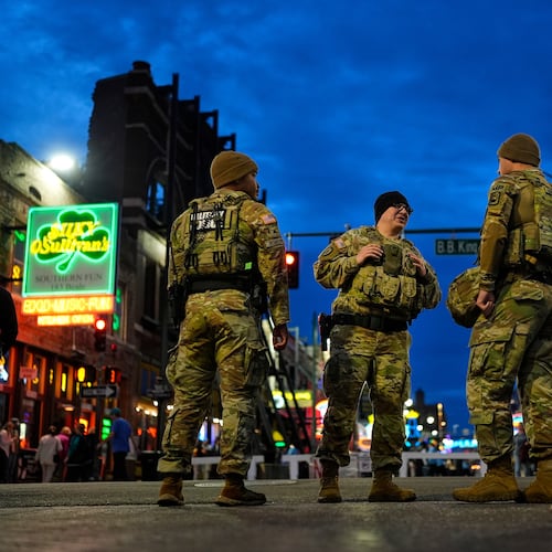 Members of the National Guard stand watch at the intersection of B.B. King Blvd. and Beale Street, Friday, Oct. 24, 2025, in Memphis, Tenn. (AP Photo/George Walker IV)