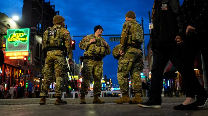 Members of the National Guard stand watch at the intersection of B.B. King Blvd. and Beale Street, Friday, Oct. 24, 2025, in Memphis, Tenn. (AP Photo/George Walker IV)